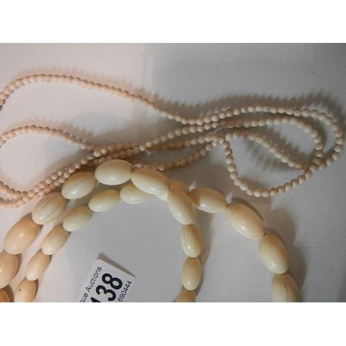 1138 - A large bead bone necklace and two coral necklaces.