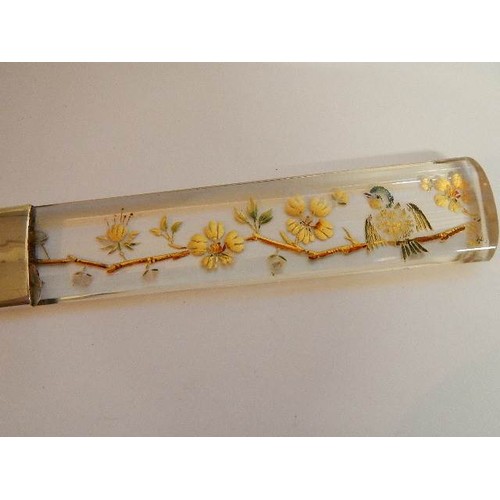 1143 - A Victorian ivory letter opener with glass handle decorated with birds and flowers. A/F