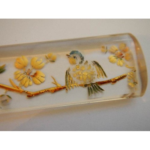 1143 - A Victorian ivory letter opener with glass handle decorated with birds and flowers. A/F