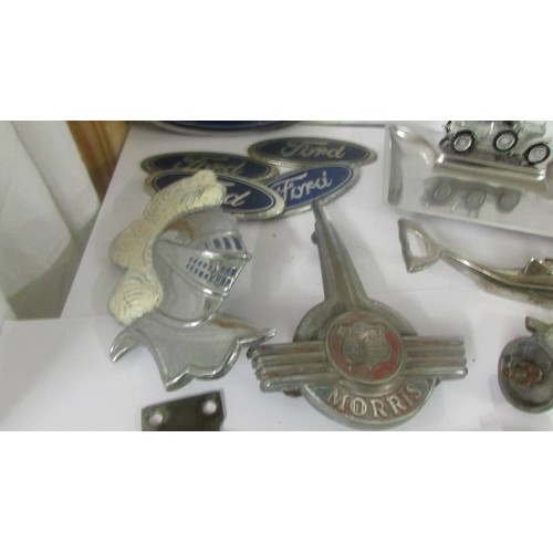 1381 - A mixed lot of car badges including Morris Minor bonnet mascot etc.,