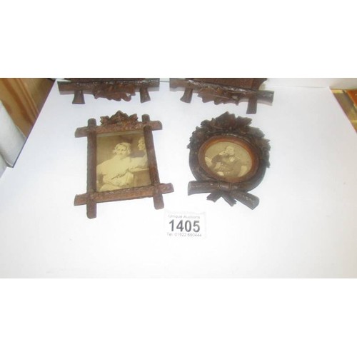 1405 - Four carved wood photograph frames.