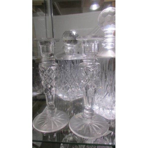 1414 - Three cut glass decanters and a pair of glass candlesticks.