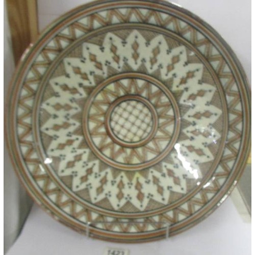 1423 - A large middle eastern ceramic dish, 42 cm diameter.