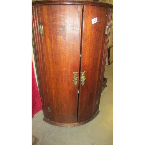 1430 - An oak corner cupboard with brass fittings, COLLECT ONLY.