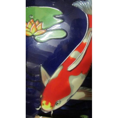 1431 - A ceramic wall plaque depicting koi carp. 36 x 28 cm.