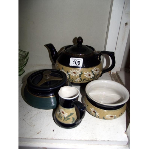 109 - A lead glazed 3 piece tea set (sugar bowl a/f) and a tobacco jar