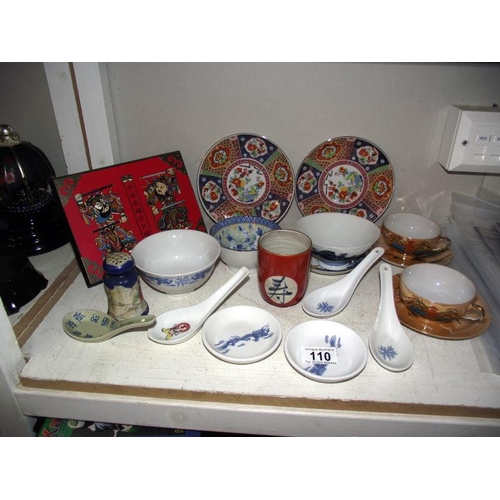 110 - A selection of Oriental pottery including tea bowls, plates, spoons etc