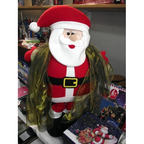 39 - A selection of Christmas items including tablecloth, napkins, singing Santa, Christmas box etc COLLE... 