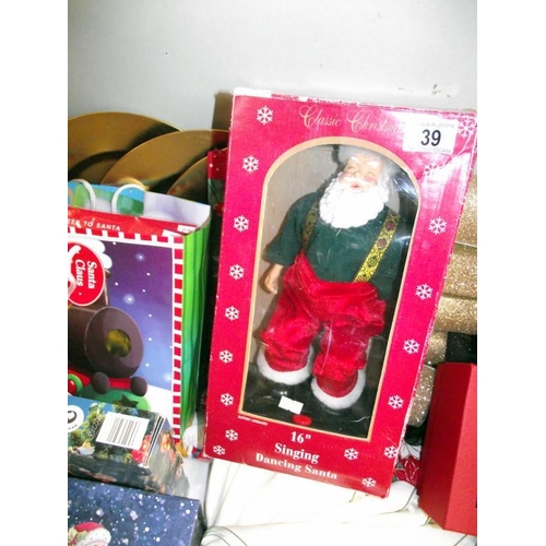 39 - A selection of Christmas items including tablecloth, napkins, singing Santa, Christmas box etc COLLE... 