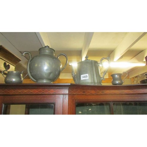 1469 - An unusual pewter teapot, another teapot, a sugar bowl and a cream jug.