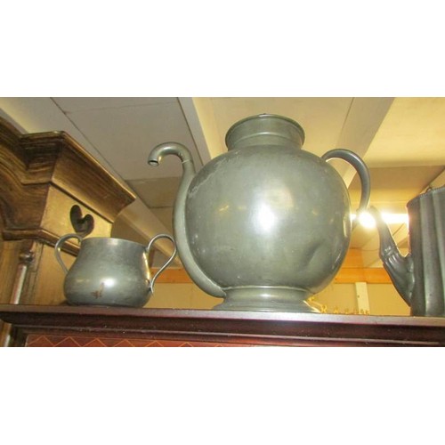 1469 - An unusual pewter teapot, another teapot, a sugar bowl and a cream jug.