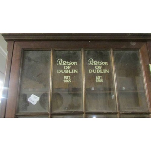 1485 - A sign written glazed cabinet, Peterson of Dublin  COLLECT ONLY.