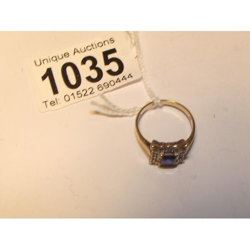 1035 - A square sapphire and diamond ring in yellow gold, size N half.