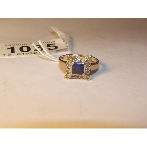 1035 - A square sapphire and diamond ring in yellow gold, size N half.