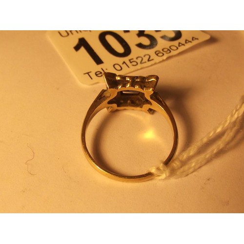 1035 - A square sapphire and diamond ring in yellow gold, size N half.