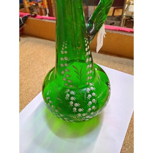 1229 - A green glass claret jug hand decorated with lily of the valley, 30cm< (a/f crack under handle).