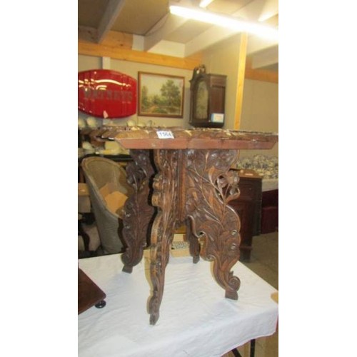 1564 - A heavily carved occasional table. COLLECT ONLY.