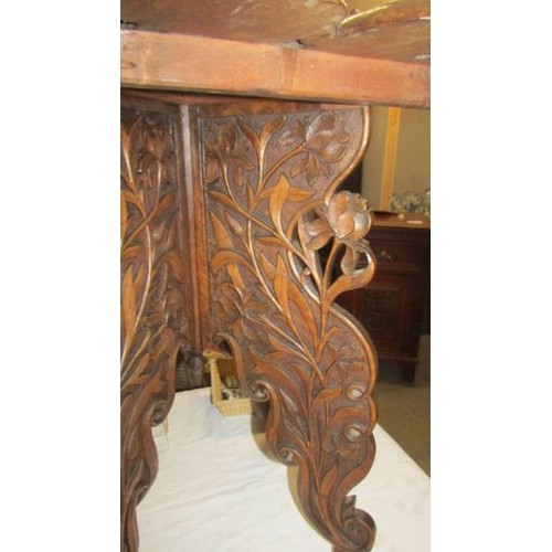 1564 - A heavily carved occasional table. COLLECT ONLY.