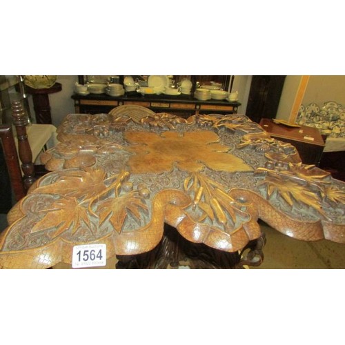 1564 - A heavily carved occasional table. COLLECT ONLY.