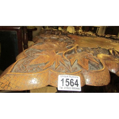 1564 - A heavily carved occasional table. COLLECT ONLY.