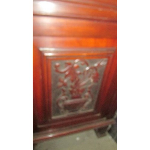 1583 - A mahogany cupboard with carved door and side panels, 95 x 56 x 56 cm.  COLLECT ONLY.