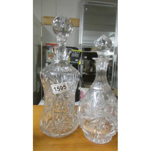 1595 - Two cut glass decanters and two cut glass vases. COLLECT ONLY.