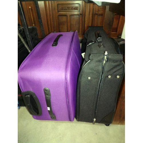 282 - A good selection of suitcases/travel cases including Mickey Mouse