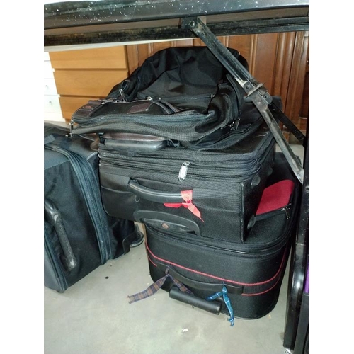 282 - A good selection of suitcases/travel cases including Mickey Mouse