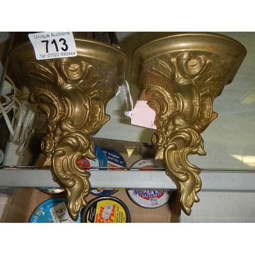 713 - A pair of brass wall brackets.