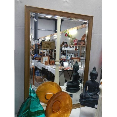 716 - A large framed bevel edged mirror. COLLECT ONLY.