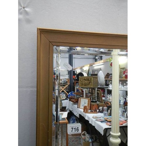 716 - A large framed bevel edged mirror. COLLECT ONLY.