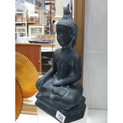 720 - A figure of a Buddha,