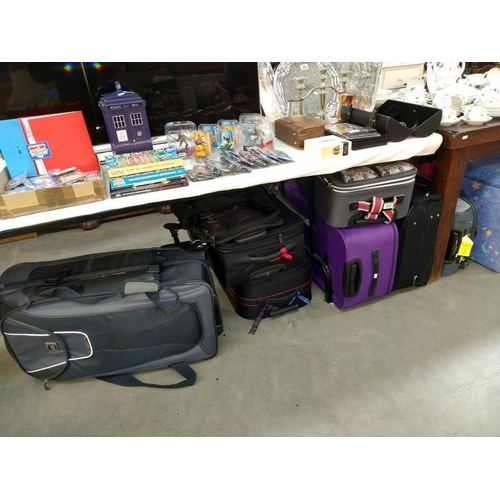 282 - A good selection of suitcases/travel cases including Mickey Mouse