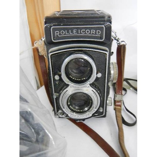 1600 - A Rolleicord camera, a cased Instamatic 100 and a Weston Master exposure meter.