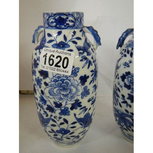 1620 - A pair of Chinese blue and white lidded vases (both lids a/f).