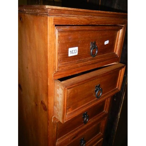 1633 - A slim seven drawer pine chest. COLLECT ONLY.