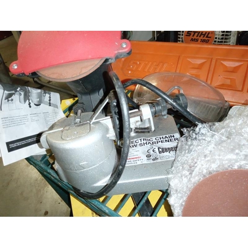 413 - A chainsaw, sharpener, protective head gear, box of chisels & level etc. COLLECT ONLY