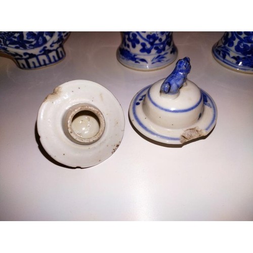 1213 - A pair of early Chinese blue & white lidded vases (both lids a/f) and a blue and white flask.