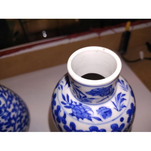 1213 - A pair of early Chinese blue & white lidded vases (both lids a/f) and a blue and white flask.