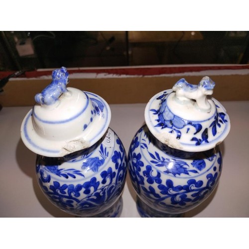 1213 - A pair of early Chinese blue & white lidded vases (both lids a/f) and a blue and white flask.