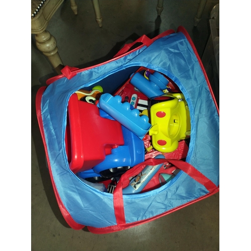 325 - A large box of toy vehicles etc, plus a pop up bin of toys and a play mat/rug, COLLECT ONLY