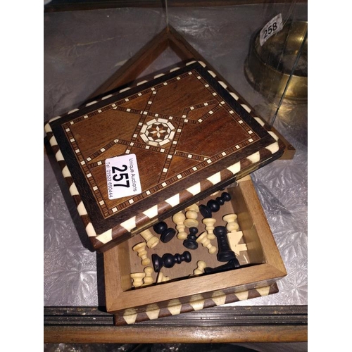 257 - An inlaid box with chessboard incorporated, chess pieces included, missing 1 black pawn