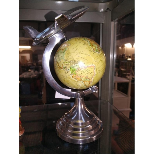 260 - An art deco style globe on polished aluminium frame with aeroplane on top height 31cm