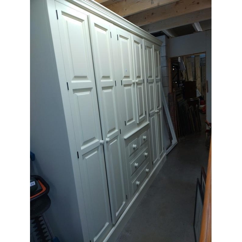 374 - A large white finished solid pine combination wardrobe (245cm x 59cm x 212cm high) COLLECT ONLY