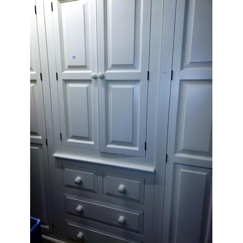 374 - A large white finished solid pine combination wardrobe (245cm x 59cm x 212cm high) COLLECT ONLY