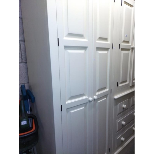 374 - A large white finished solid pine combination wardrobe (245cm x 59cm x 212cm high) COLLECT ONLY