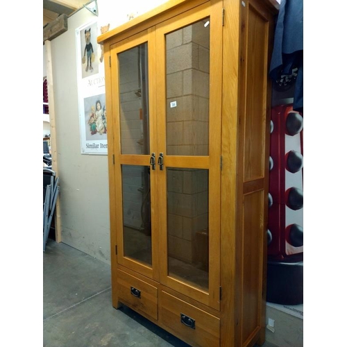 386 - A solid oak 2 door display cabinet with drawers (100cm x 40cm x 180cm) COLLECT ONLY