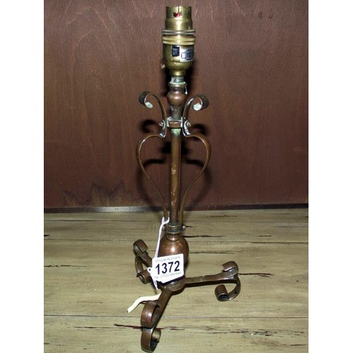 1372 - An Arts and Crafts copper lamp in the style of Benson, 34 cm tall.