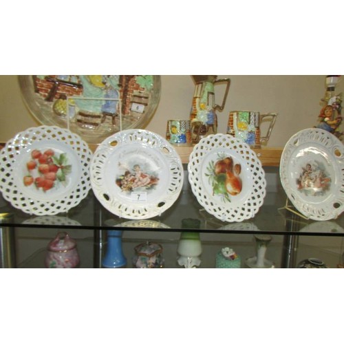 7 - Two Cherub and two floral ribbon plates.