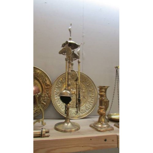 24 - A mixed lot of brass and copper including companion set, scales, kettle on stand etc., COLLECT ONLY.